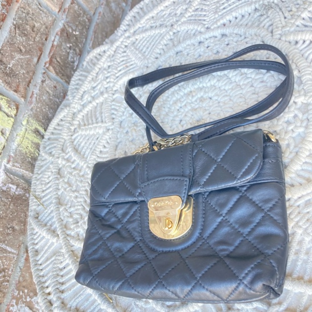 Calvin Klein quilted leather turn-lock crossbody bag.